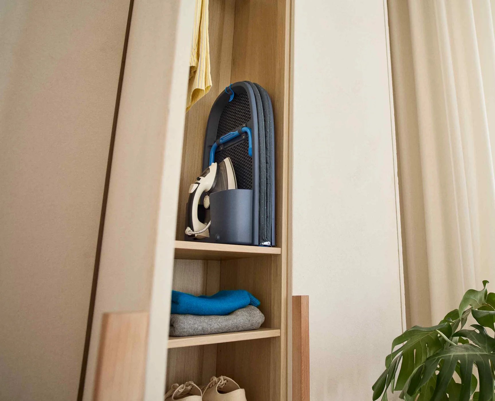 Joseph Joseph navy compact ironing board in alcove